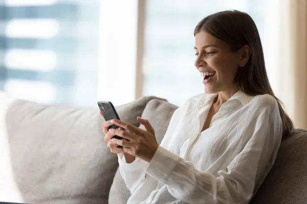 Happy woman looking at the phone
